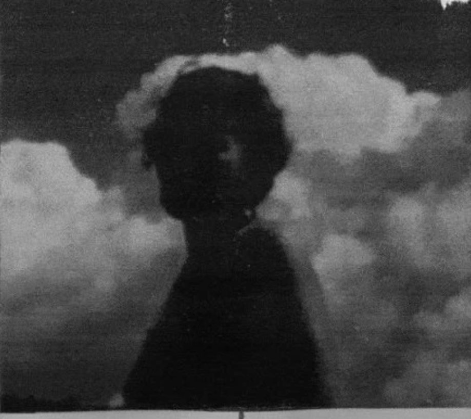 a figure on a porch, backlit, face in shadow